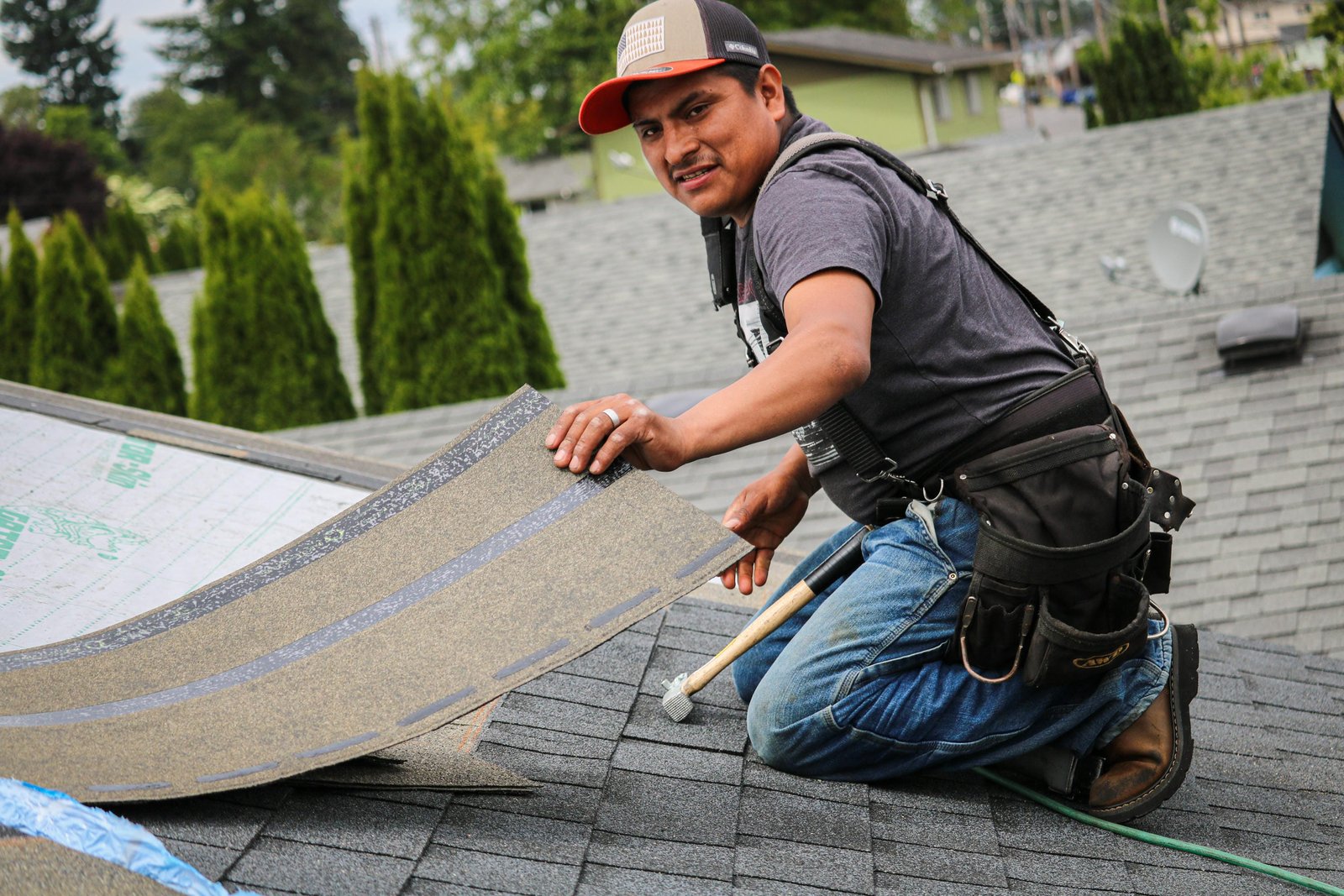 Professional roofer installing underlayment in Longview, WA